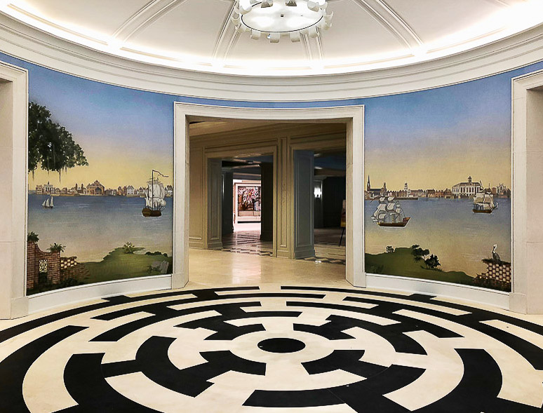 Low country mural installed in hotel rotunda walls with striking black and white flooring